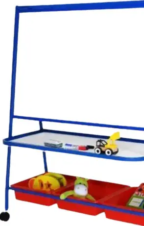 A child height easel with a blue painted steel frame on castors, a white board, a shelf holding markers and a toy digger, and three red storage trays beneath it.