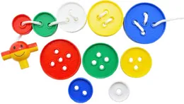 Large plastic buttons of different sizes in red, blue, yellow, green and white, some threaded onto a white lace.