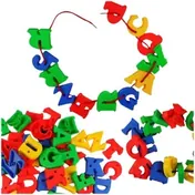Plastic capital letters in red, blue, green and yellow, a line of them threaded onto a red lace above a heap of loose ones.