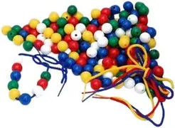 A heap of small wooden beads in red, blue, green, yellow and white with coloured laces.