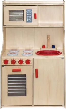 A birch play kitchen with a microwave and cupboard above, a red bowl set into the worktop beside two drawn hobs, four red control knobs and an oven with a glass door.