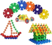 Cogged plastic discs in red, blue, green, orange and purple, joined into an arch above a heap of smaller ones built into a cone and a bush.