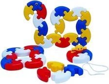 Interlocking curved plastic pieces in red, blue, yellow and white, joined into rings and a chain.