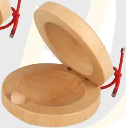 A pair of pale wooden castanets tied with red cord, the top shell propped open.