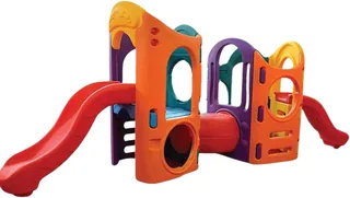 A plastic climbing unit in orange and purple with a red slide at each end, a tunnel through the middle and a climbing wall panel.
