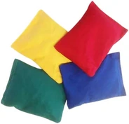 Four fabric bean bags in yellow, red, green and blue.
