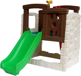 A plastic climbing frame with a brown timber-effect deck and rails, white stone-effect walls, and a green slide running down from the platform.