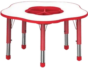 A flower shaped white table on red adjustable legs, with a red divided tray set into the centre.