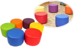 Round upholstered stools in many colours, grouped together.