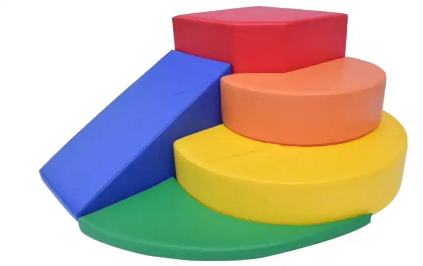 A blue ramp onto a green semicircle, with orange and yellow tiers and a red block on top.
