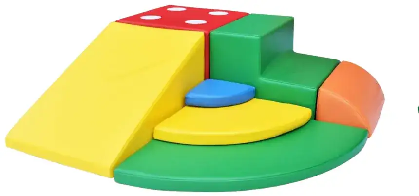 A yellow ramp onto a green semicircle, with a red spotted top and an orange quarter block.
