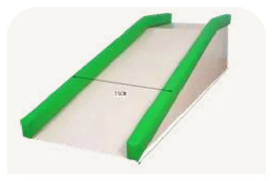 A pale ramp with a green padded rail down each side.