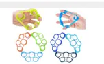 Silicone finger loop trainers in four colours, two held in hands.