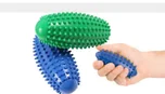 Green and blue spiked oval massage balls, one held in a hand.
